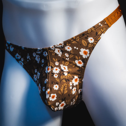 Men's brown earth tone floral thong underwear, classic cut, angled front view.