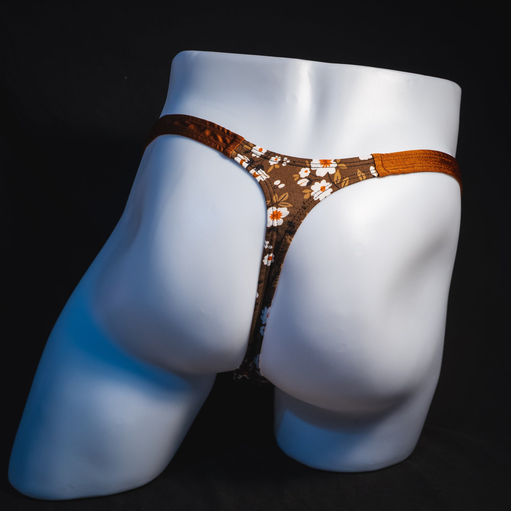 Men's brown earth tone floral thong underwear, classic cut, full rear view.
