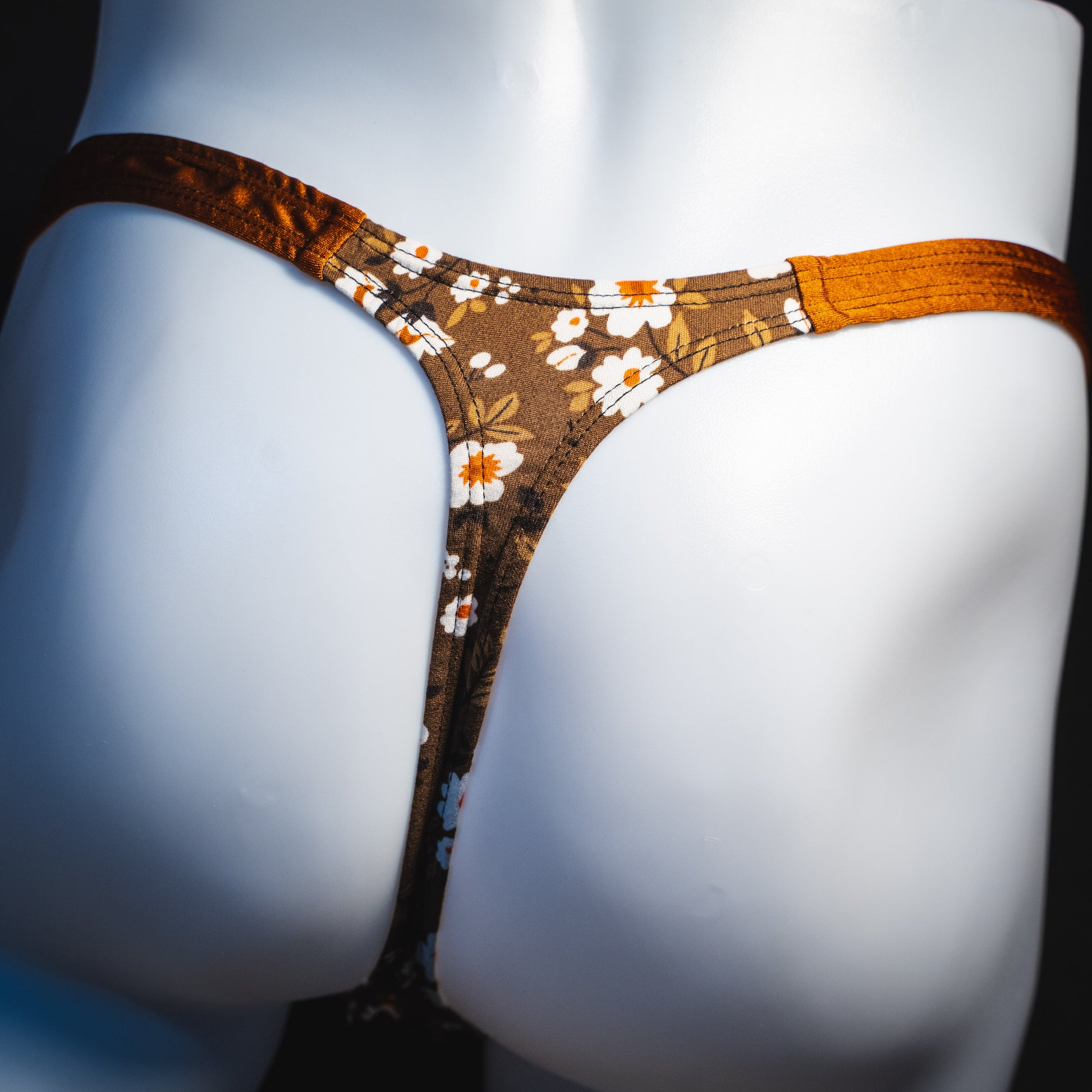 Men's brown earth tone floral thong underwear, classic cut, rear view.