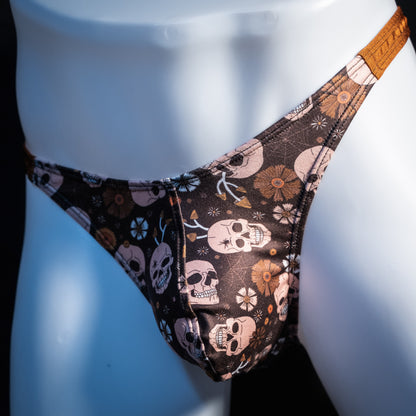 Men's brown skull patterned thong underwear, classic cut, front view.