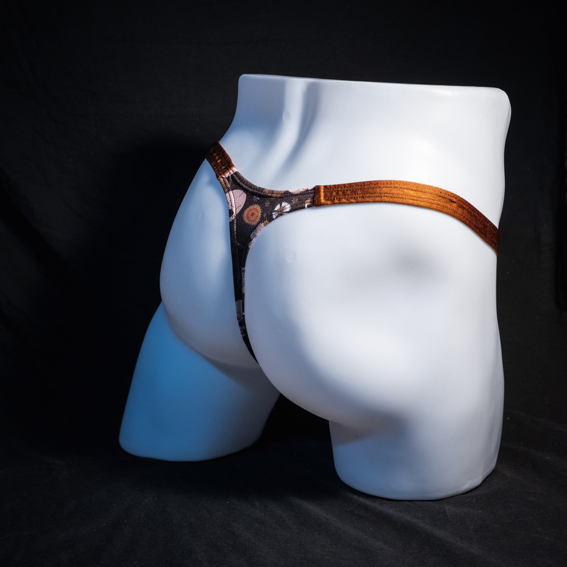 Men's brown skull patterned thong underwear, classic cut, rear view.