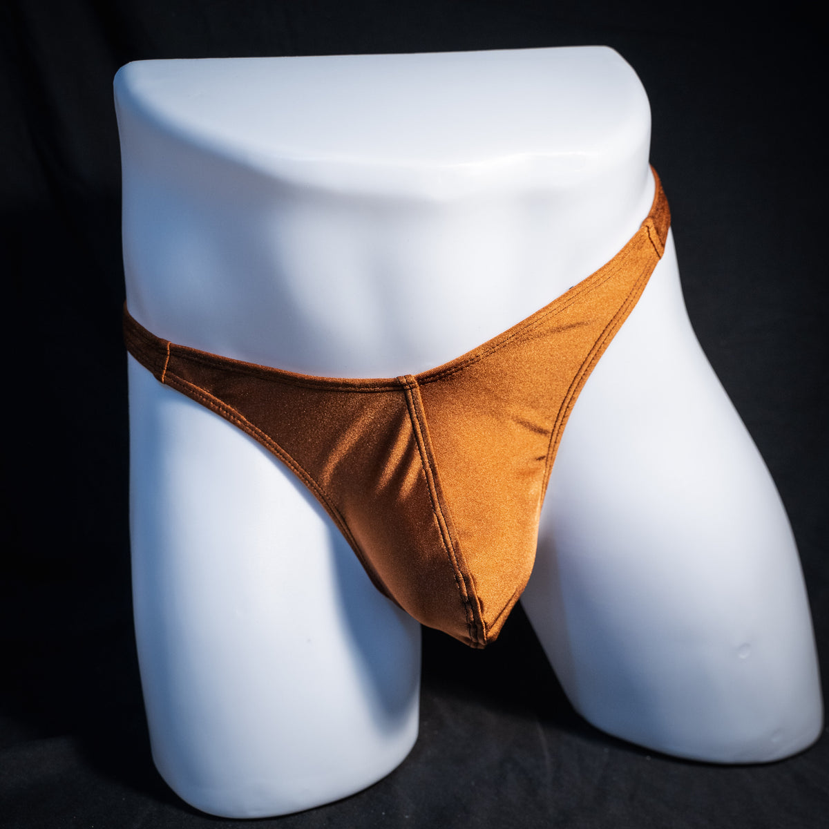 Men's solid brown spandex thong underwear, classic cut, front view.