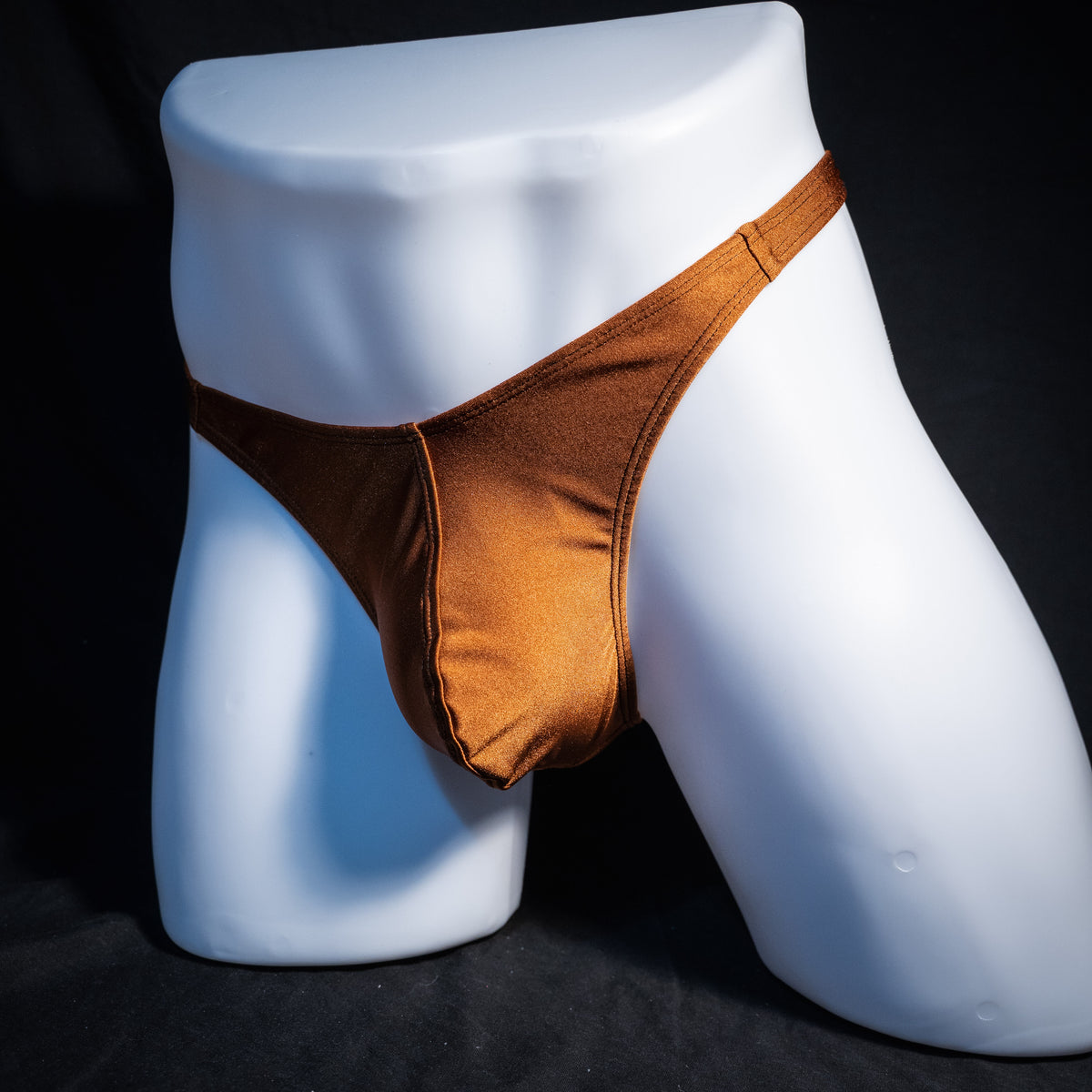 Men's solid brown spandex thong underwear, classic cut, front view.