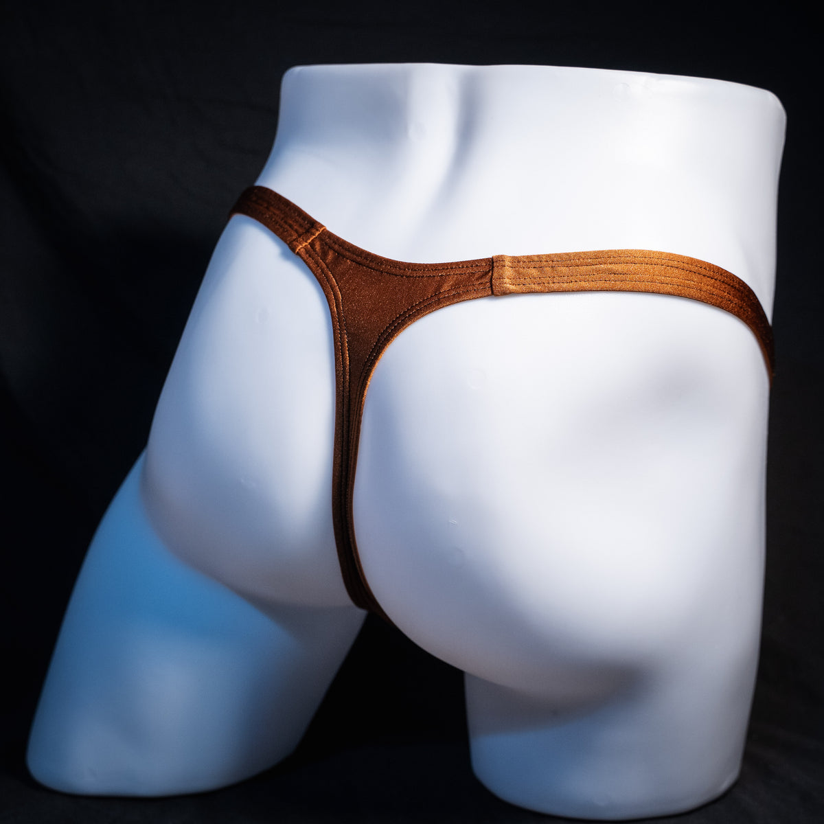 Men's solid brown spandex thong underwear, classic cut, rear view.