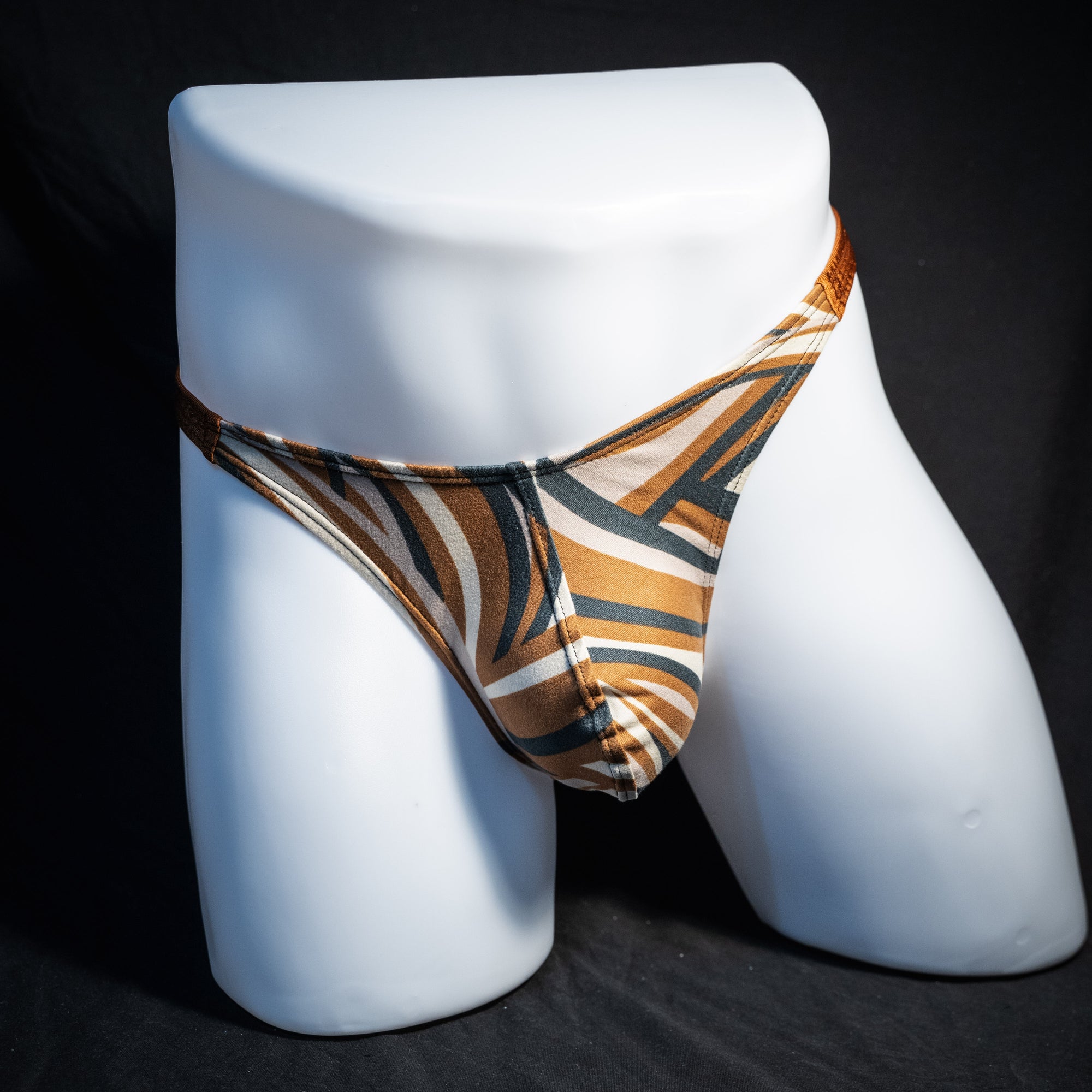 Men's brown and tan thong underwear, classic cut, front view.