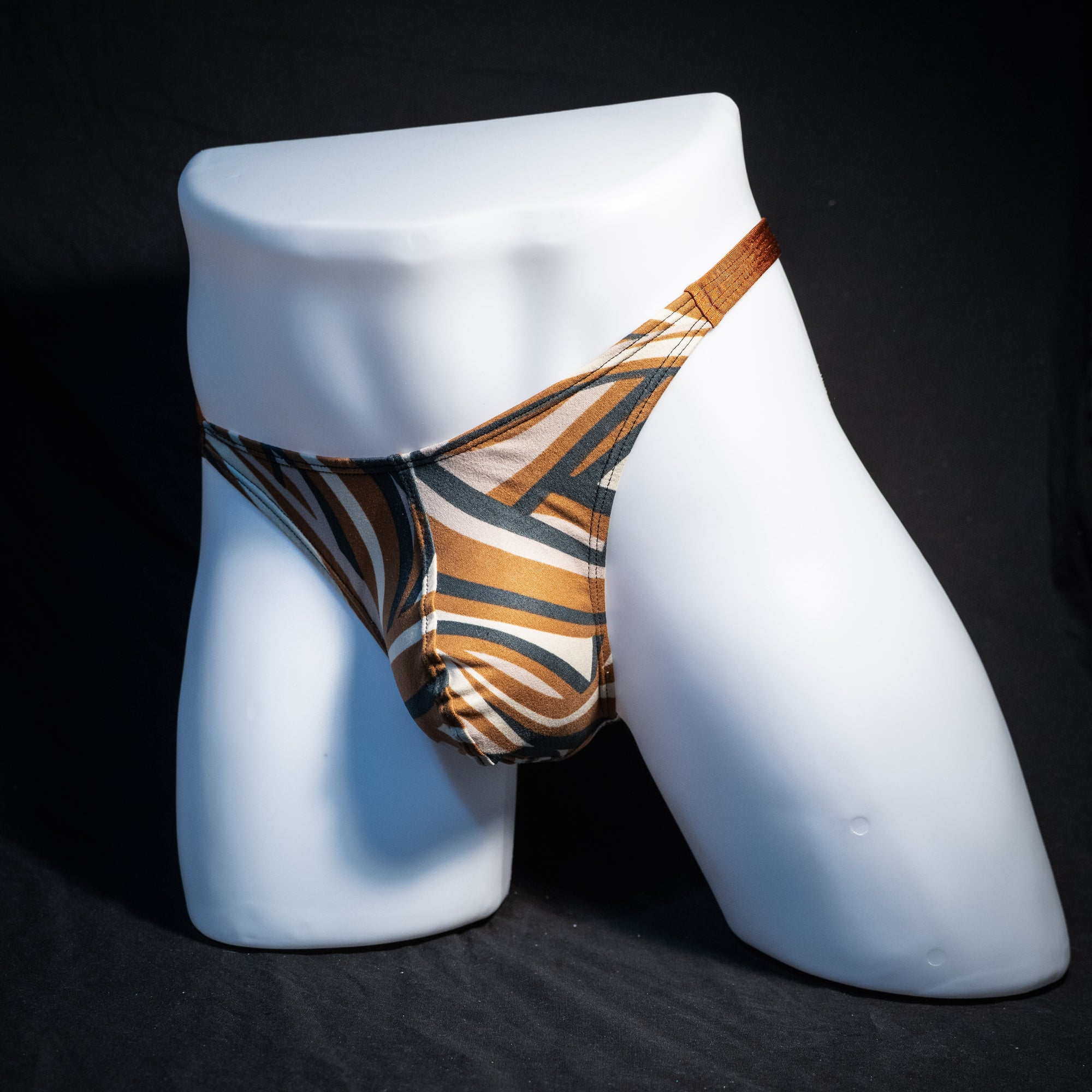 Men's brown and tan thong underwear, classic cut, front view.