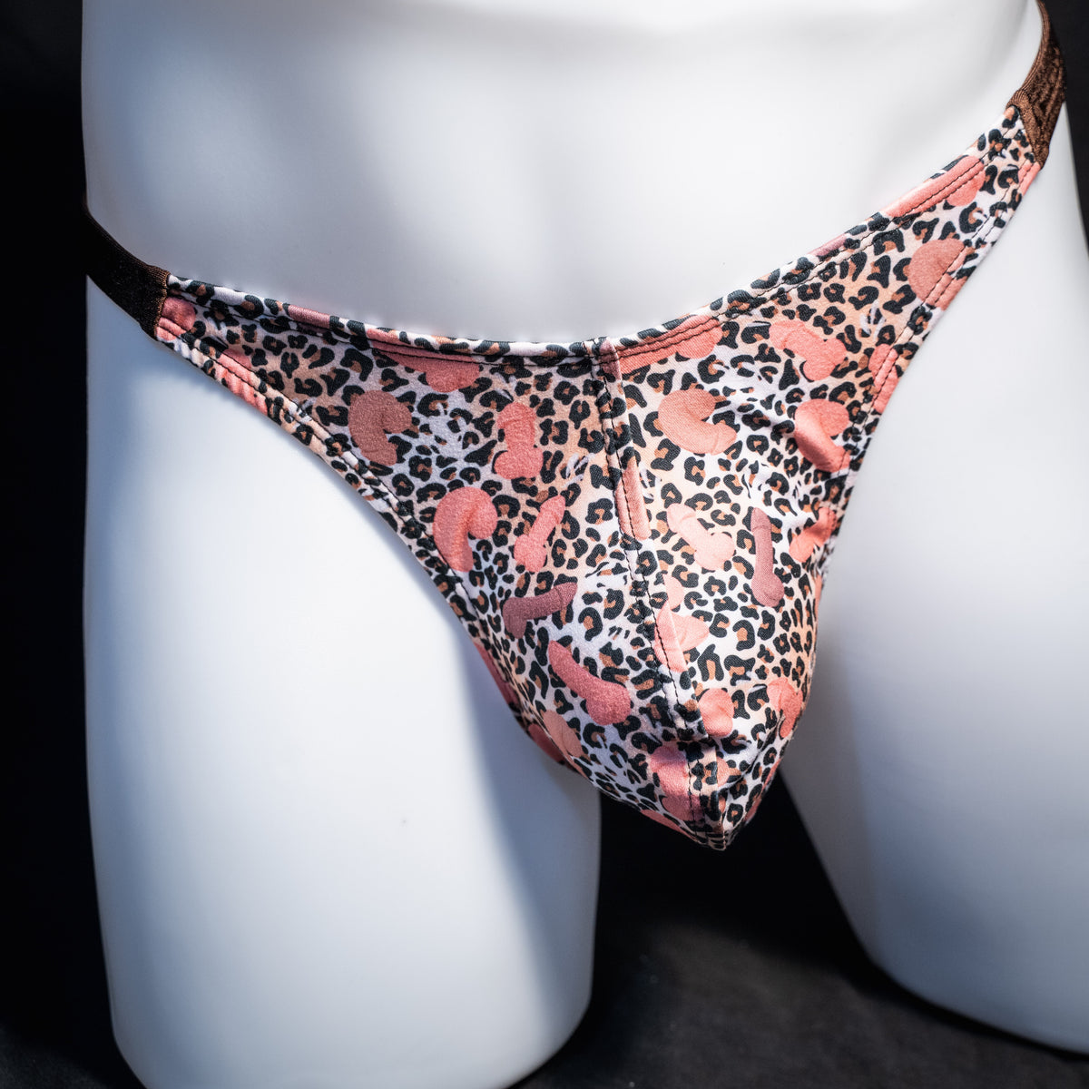 Men's cheetah print thong underwear with penises, classic cut, front view.