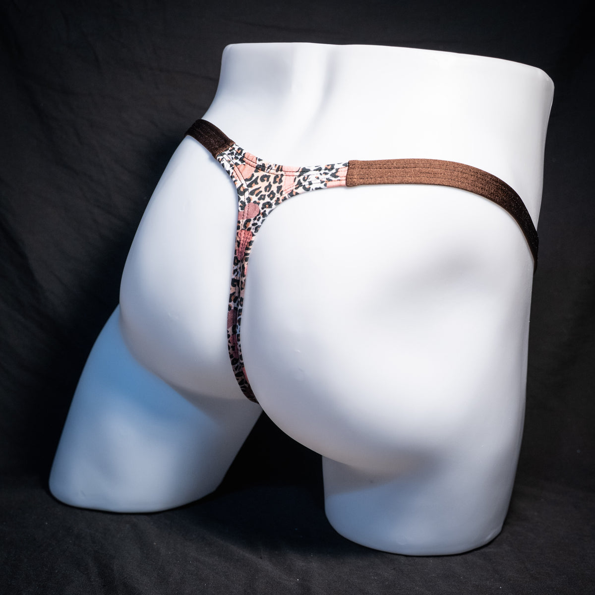 Men's cheetah print thong underwear with penises, classic cut, rear view.