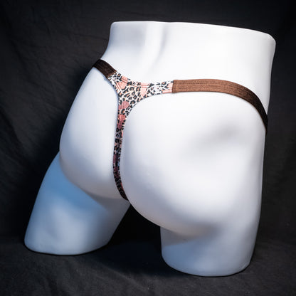 Men's cheetah print thong underwear with penises, classic cut, rear view.