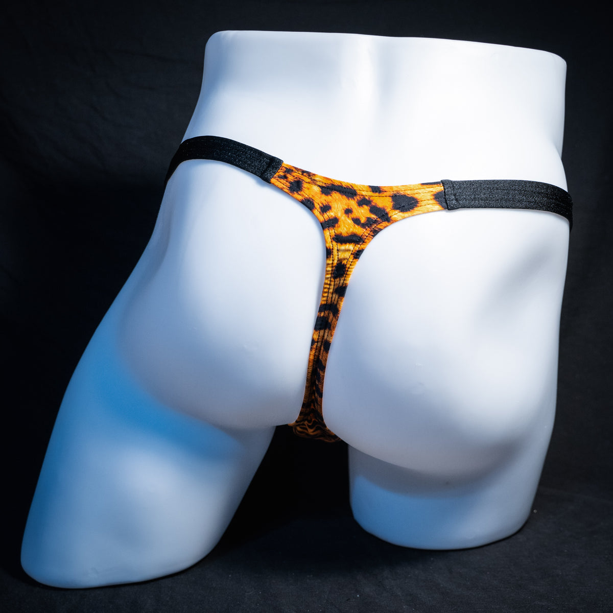Men's cheetah print thong underwear, classic cut, rear view.