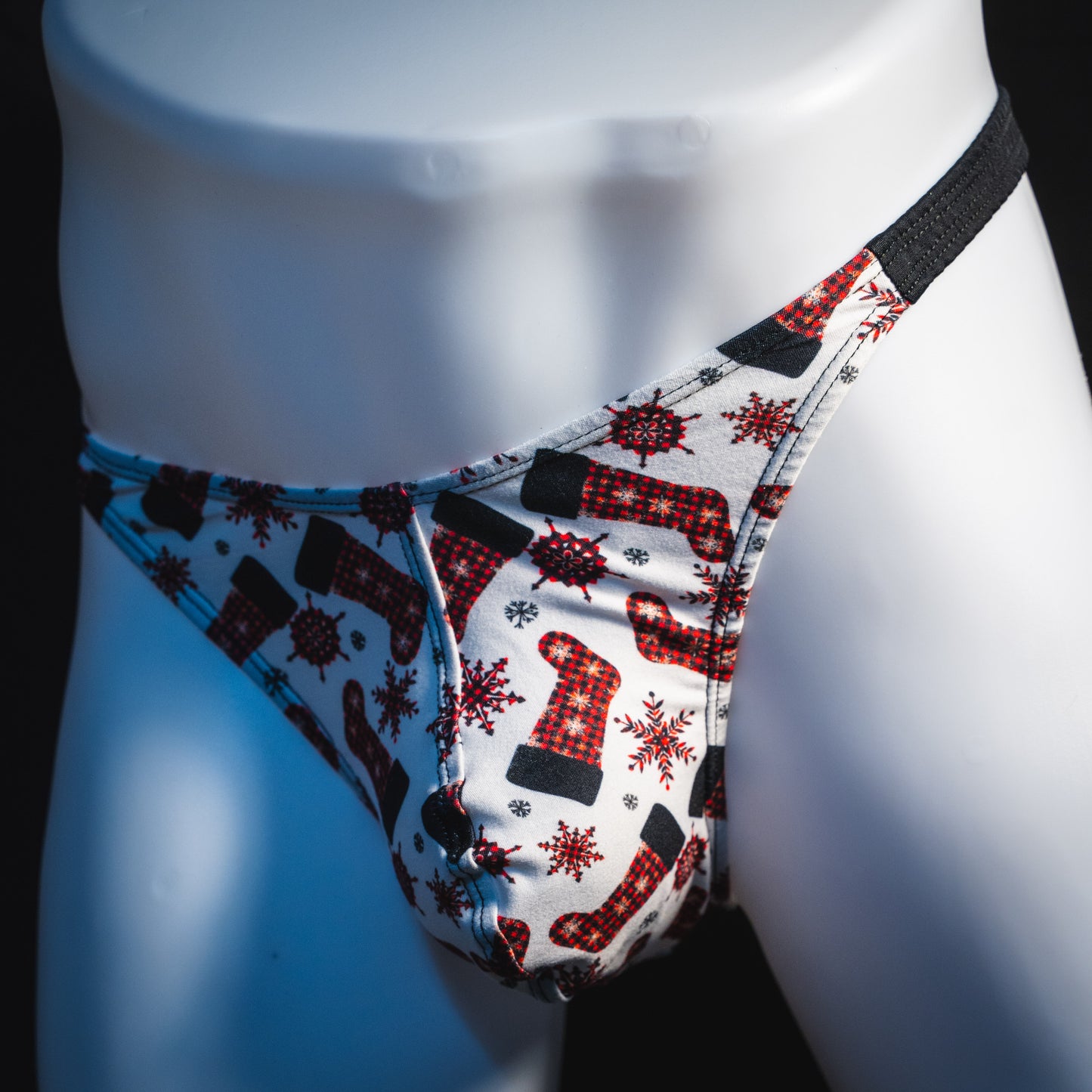Men's Christmas stockings thong underwear, classic cut, front angled view.