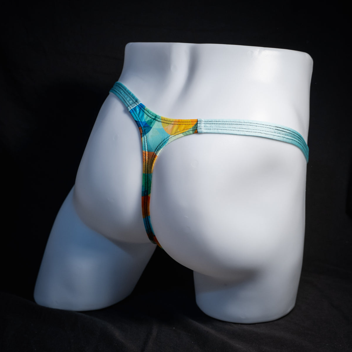 Men's colorful thong underwear, classic cut, rear view.