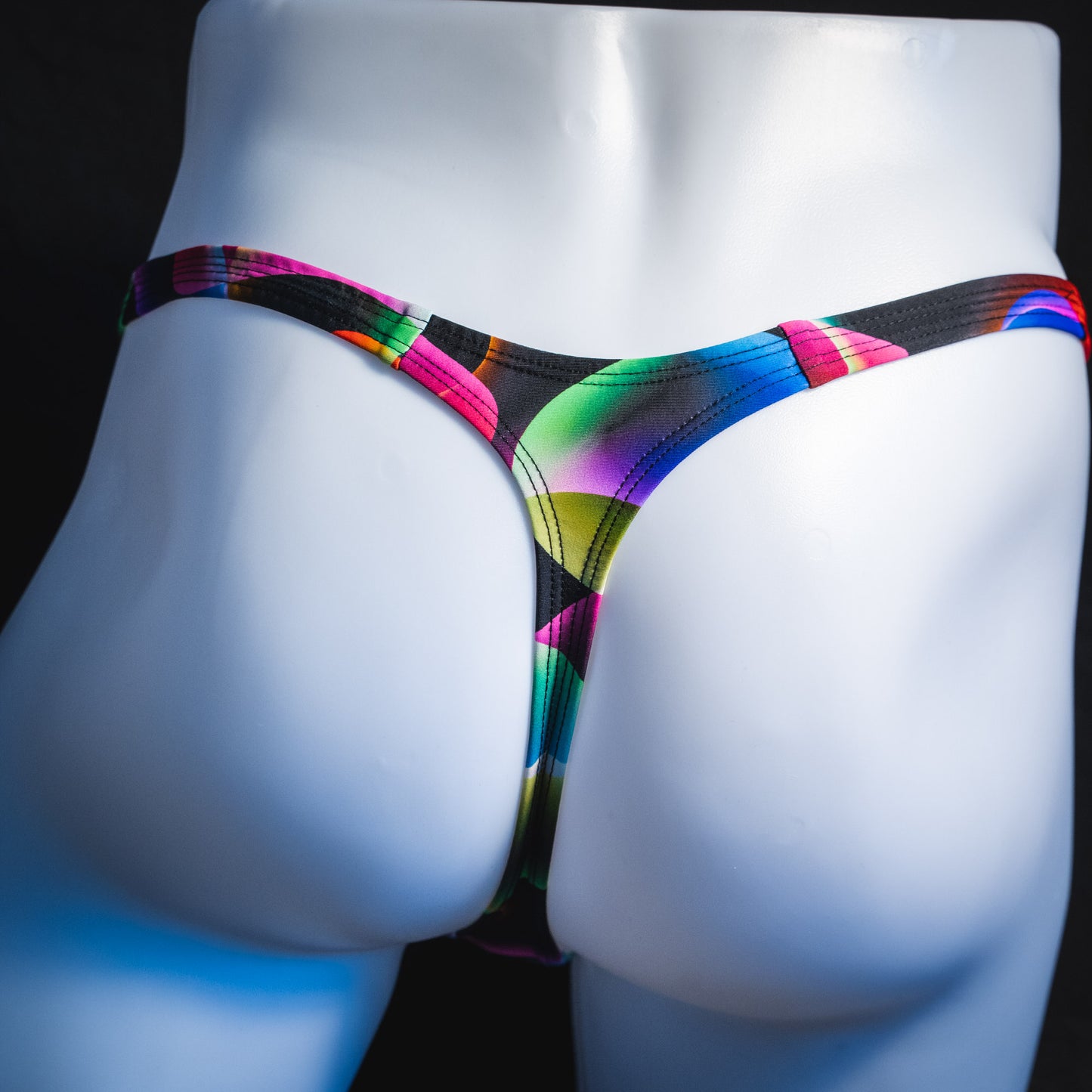 Men's colorful thong underwear, tower cut, rear view.