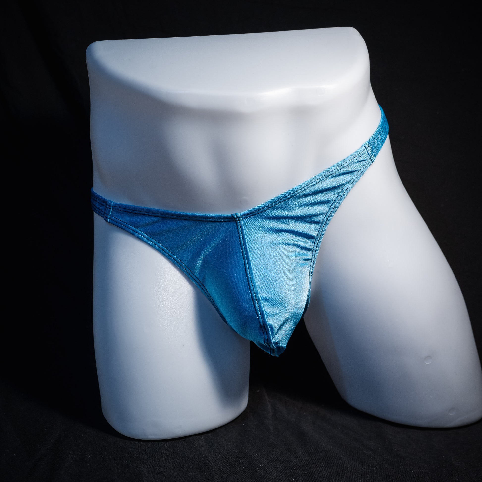 Men's columbia blue thong underwear, classic cut, front view.