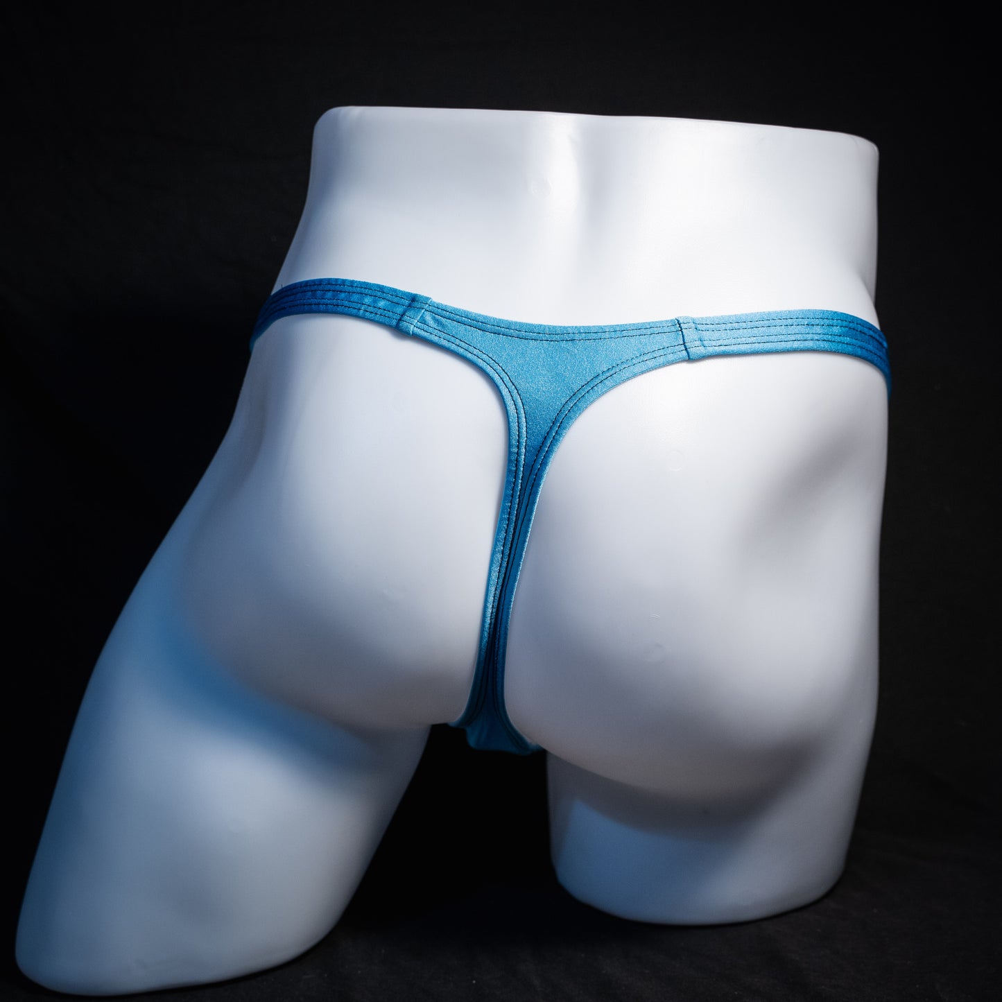 Men's columbia blue thong underwear, classic cut, rear view.
