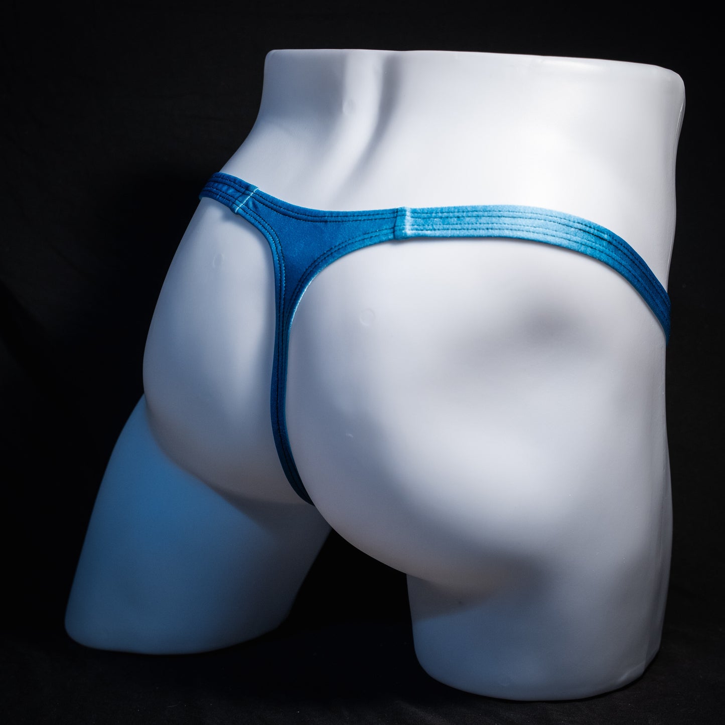 Men's columbia blue thong underwear, classic cut, rear view.