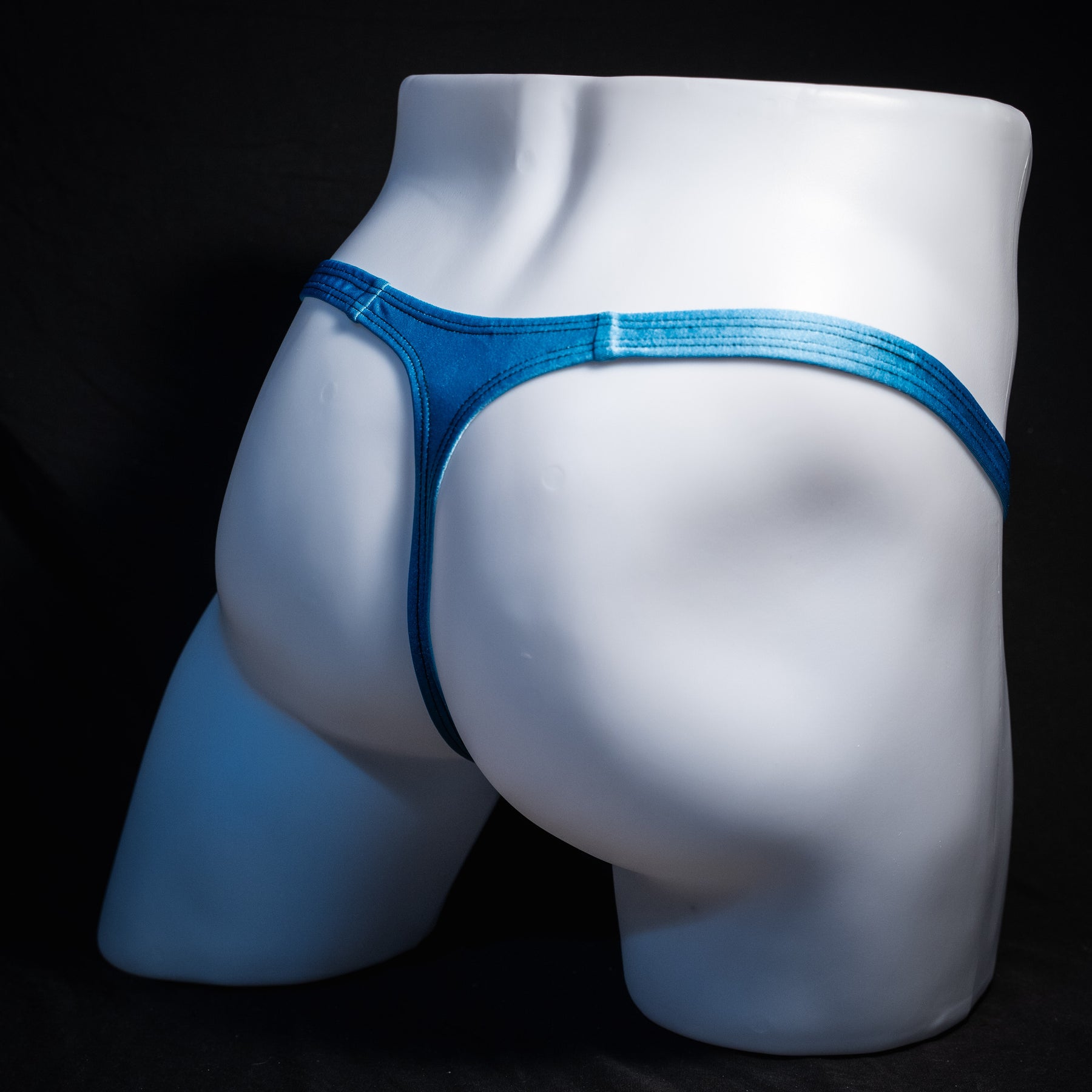 Men's columbia blue thong underwear, classic cut, rear view.