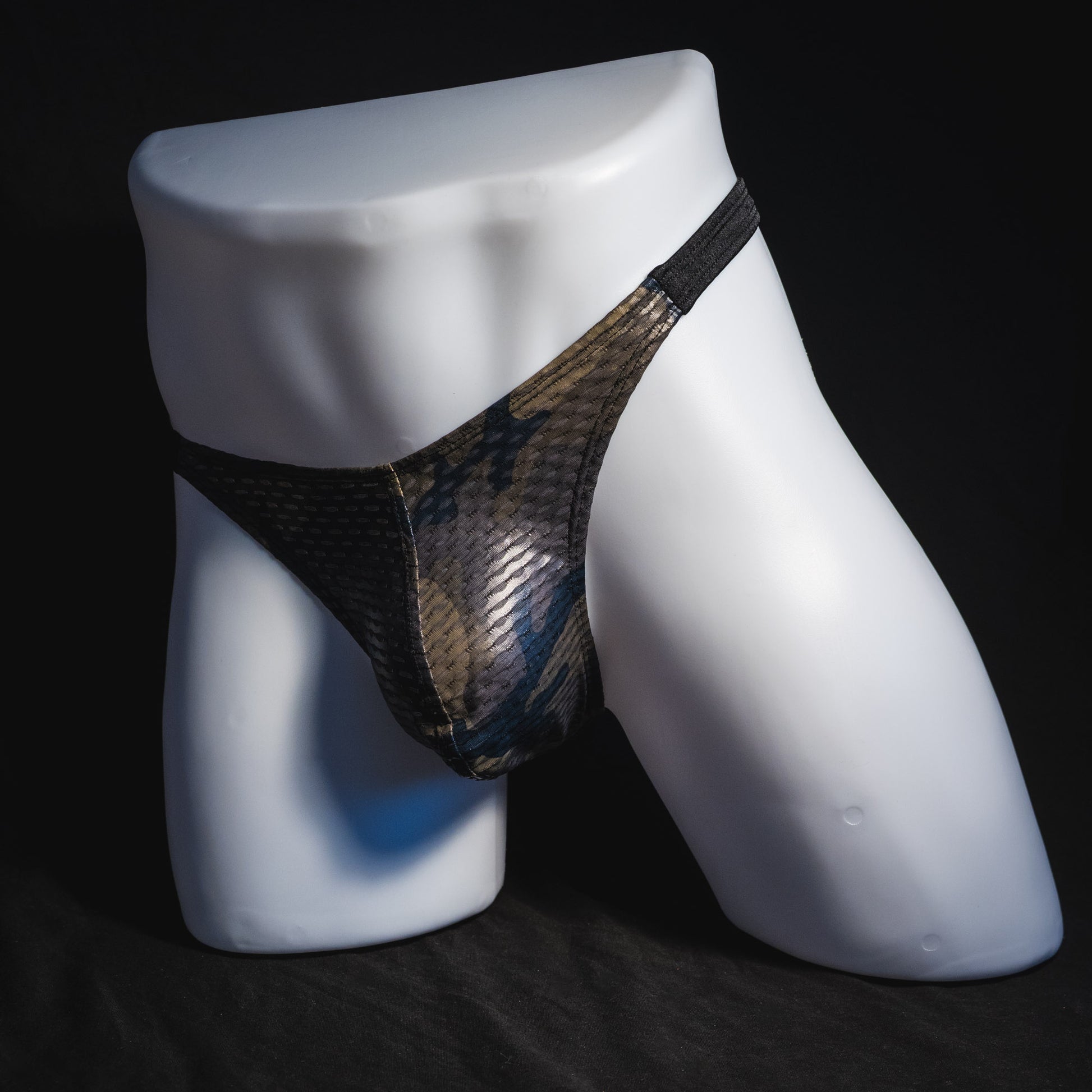 Men's dark camo athletic mesh thong underwear, classic cut, angled full front view.