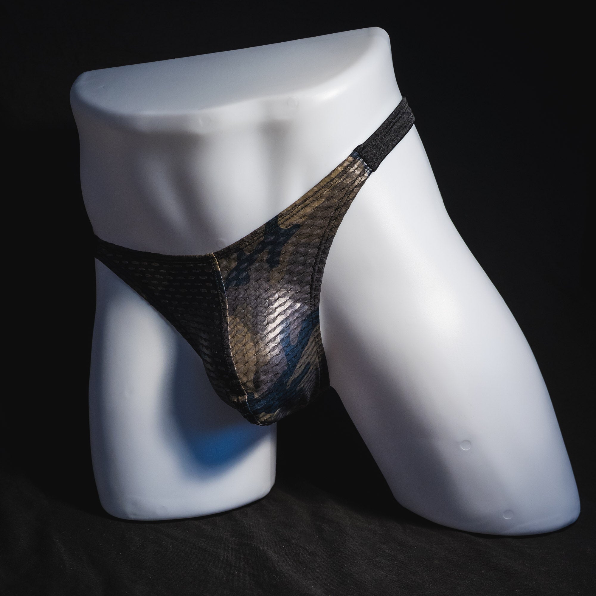Men's dark camo athletic mesh thong underwear, classic cut, angled full front view.
