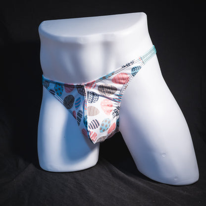 Men's Easter eggs thong underwear, classic cut, full front angled view.