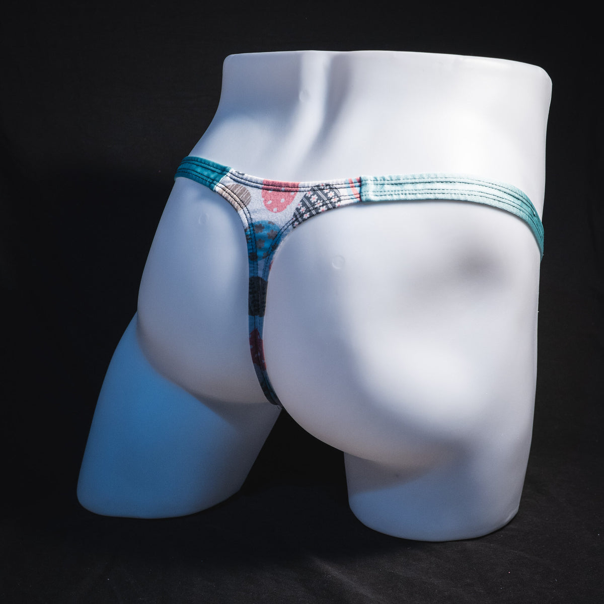 Men's Easter eggs thong underwear, classic cut, full angled rear view.