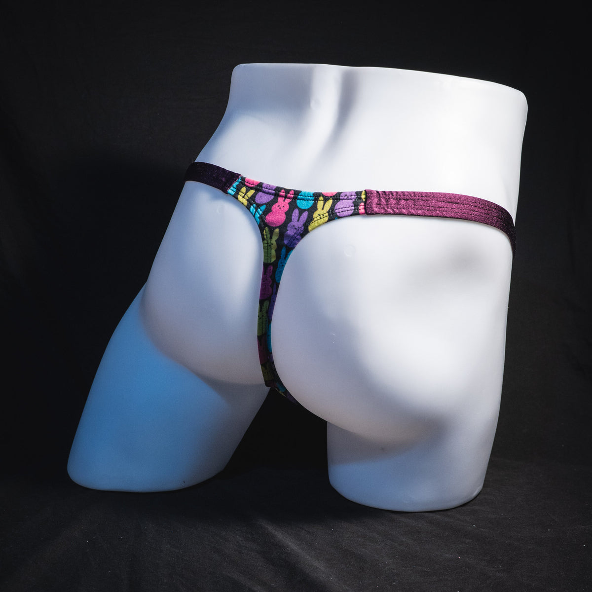 Men's colorful bunnies thong underwear, classic cut, full rear angled view.