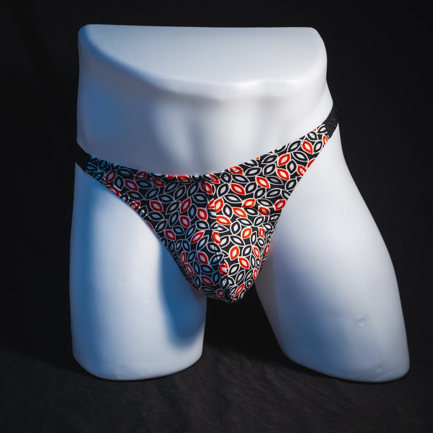 Men's black white and red petal thong underwear, classic cut, full front view.