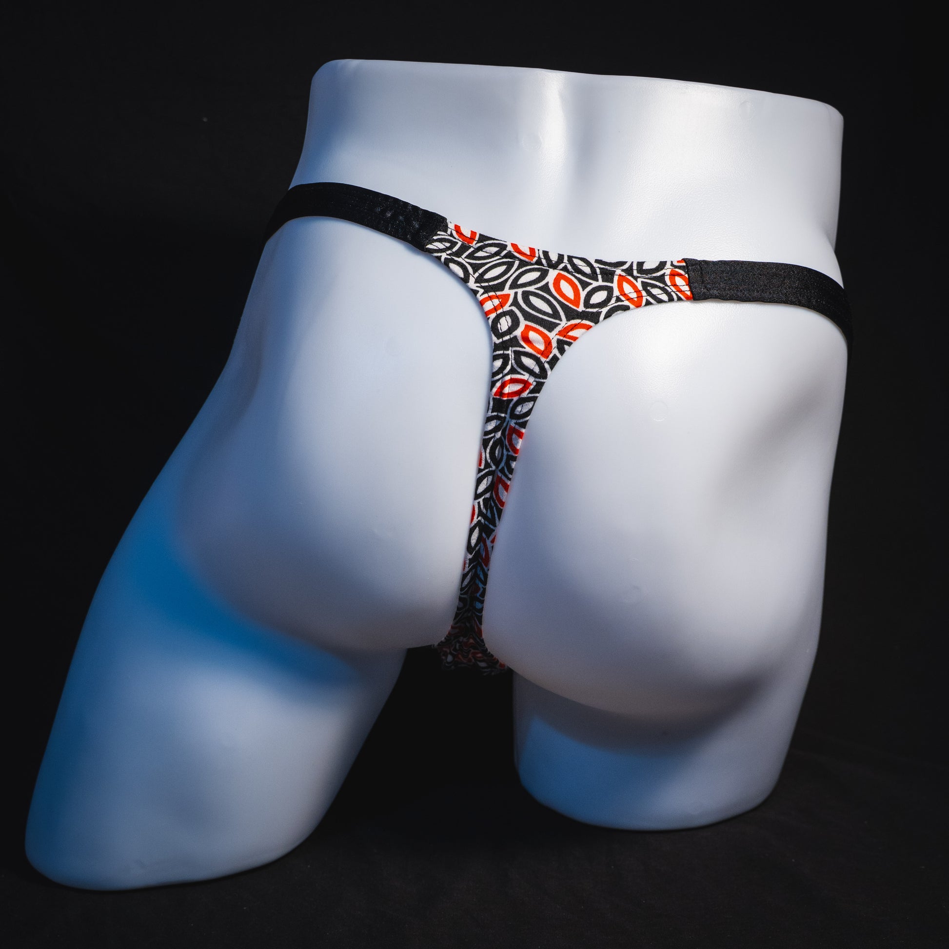 Men's black white and red petal thong underwear, classic cut, full rear view.