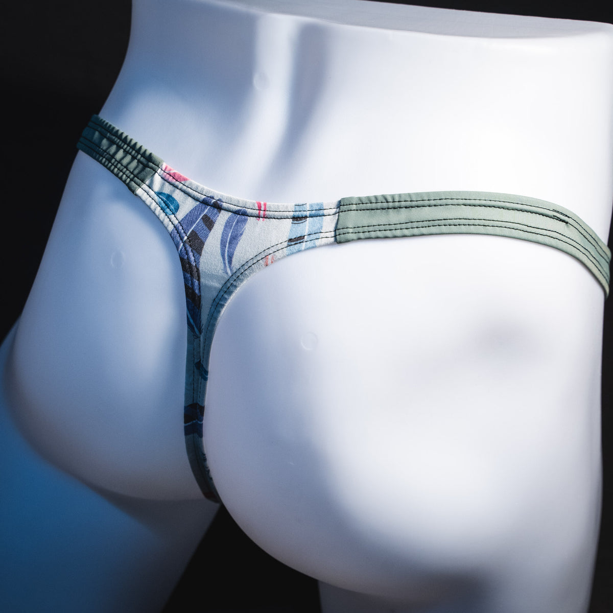 Men's feather patterned thong underwear, classic cut, angled rear view