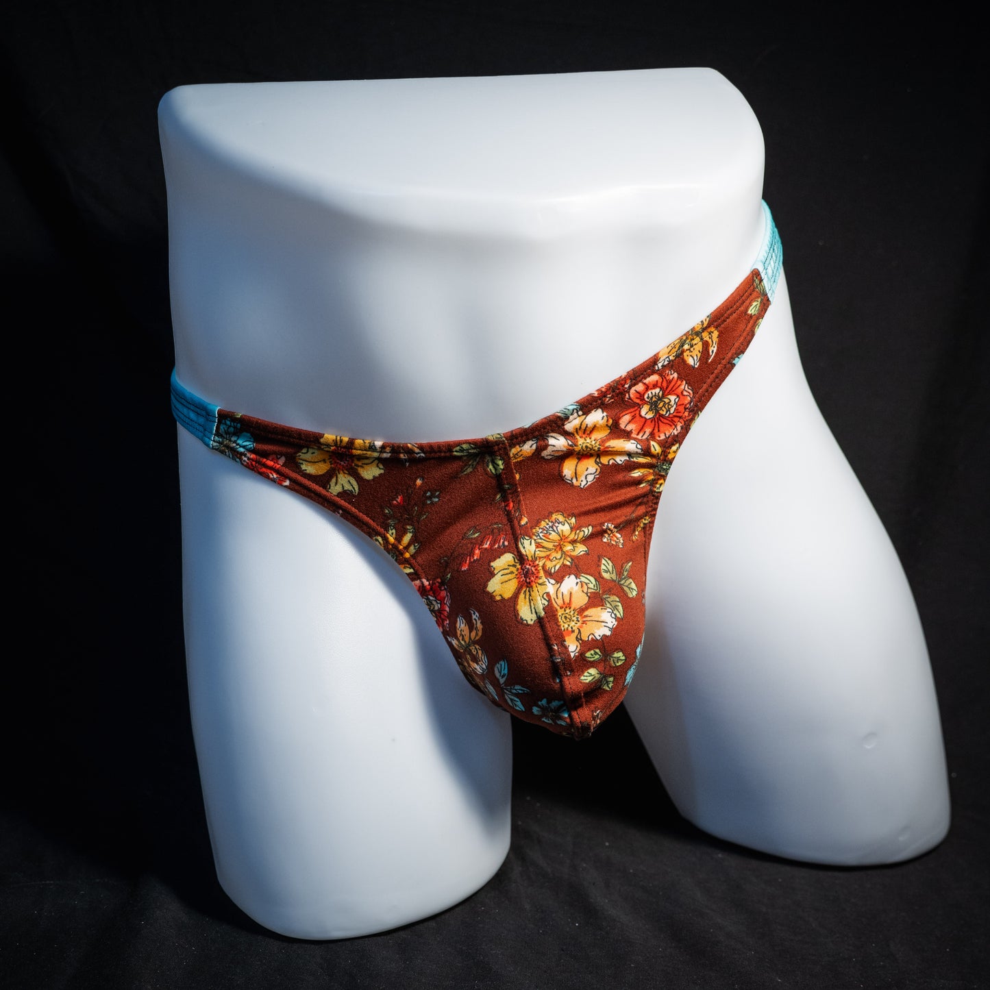 Men's floral thong underwear, classic cut, front view.