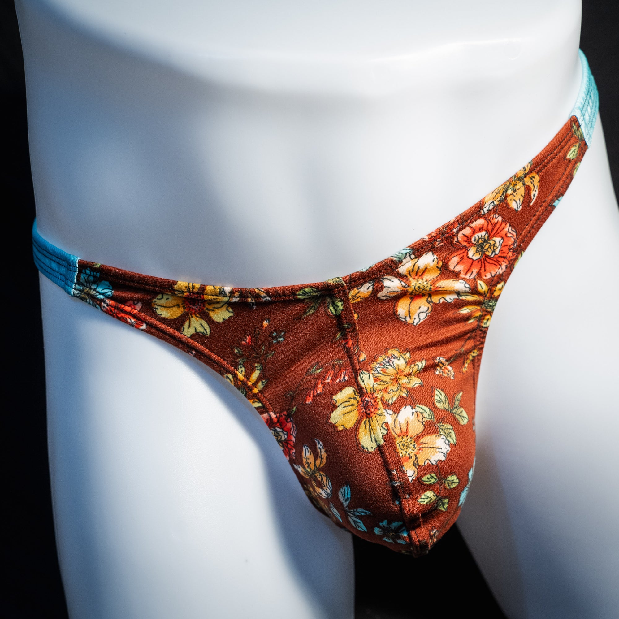 Men's floral thong underwear, classic cut, front view.