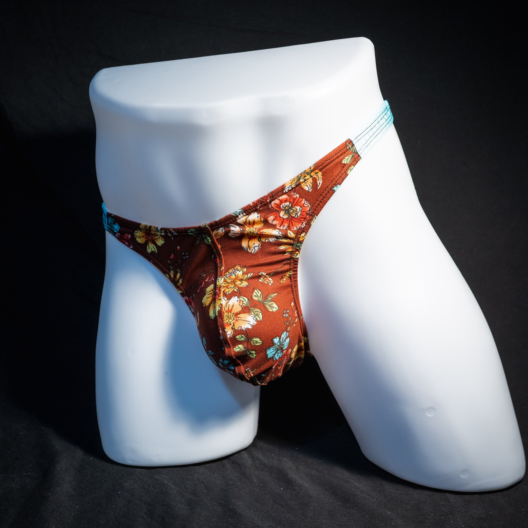 Men's floral thong underwear, classic cut, front view.