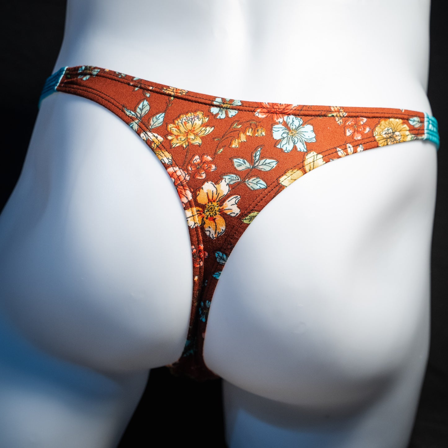 Men's floral thong underwear, classic cut, back view.