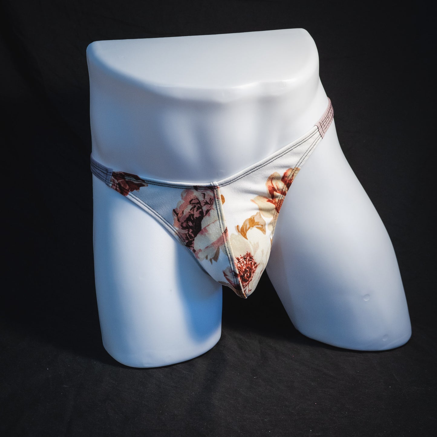 Men's ivory floral thong underwear, classic cut, full front view.