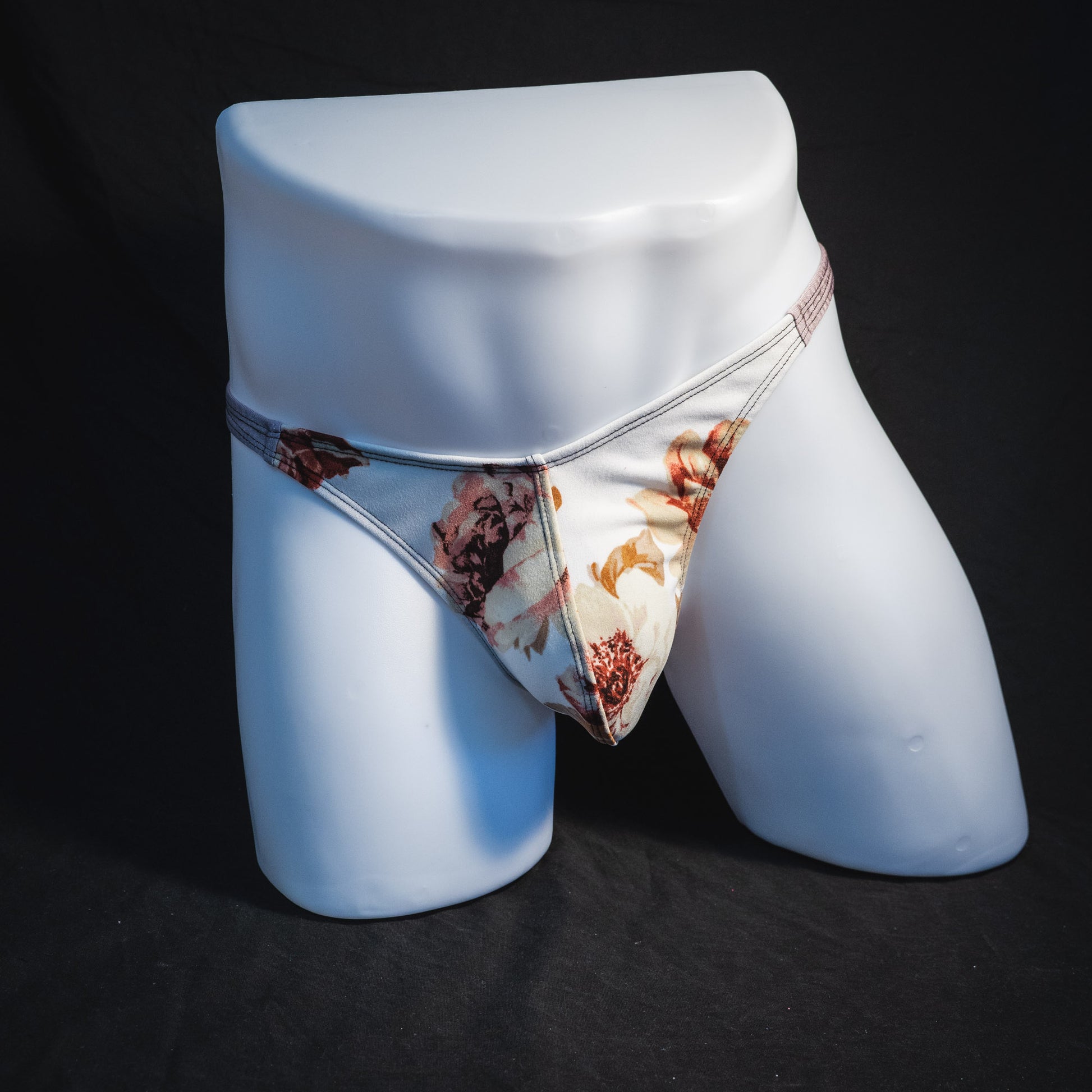 Men's ivory floral thong underwear, classic cut, full front view.