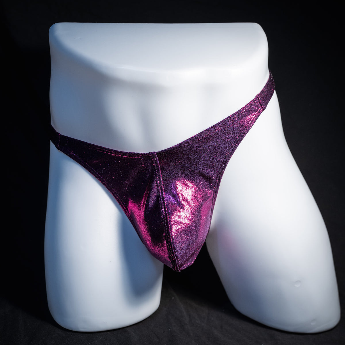 Men's fuchsia metallic thong underwear, classic cut, front view.