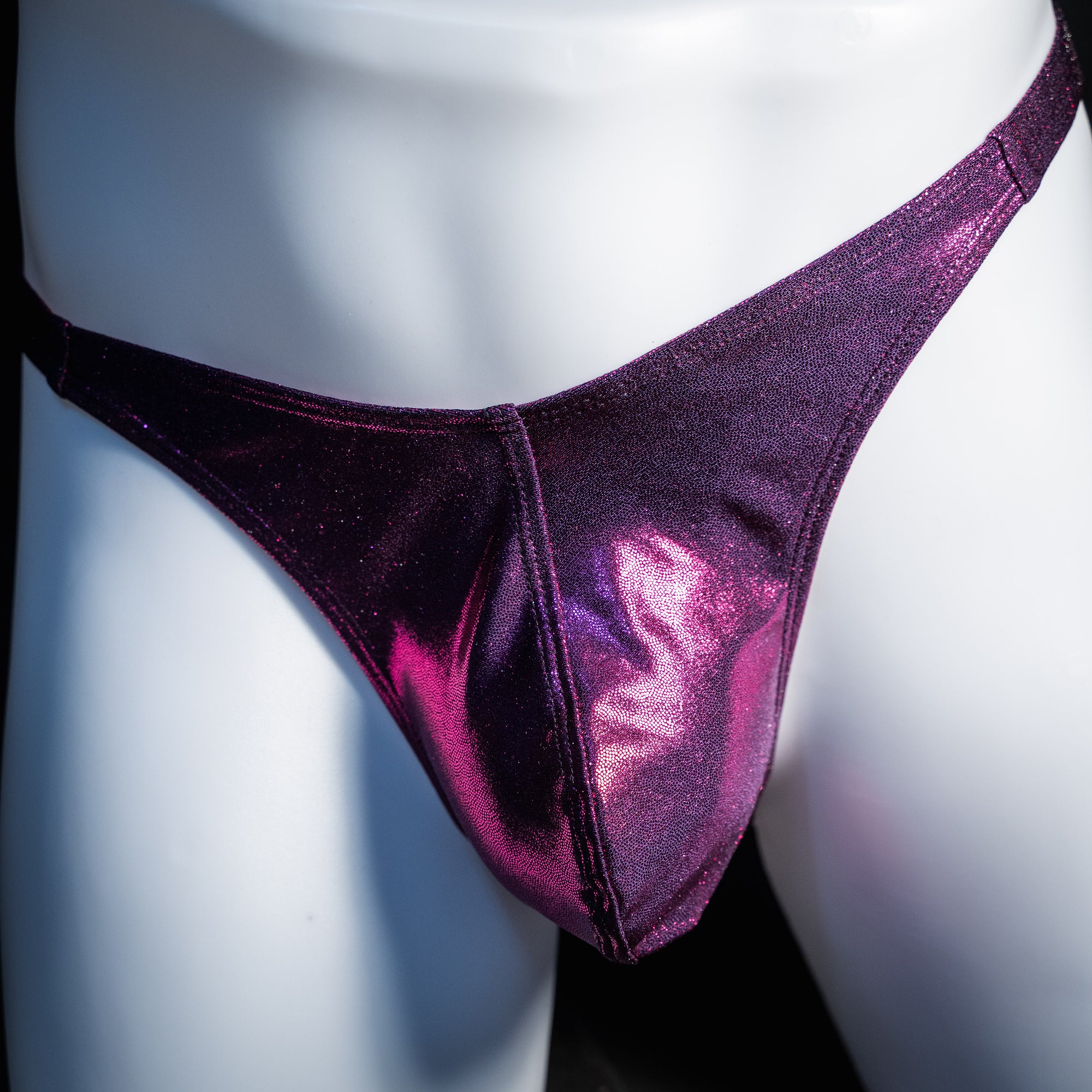 Men's fuchsia metallic thong underwear, classic cut, front view.