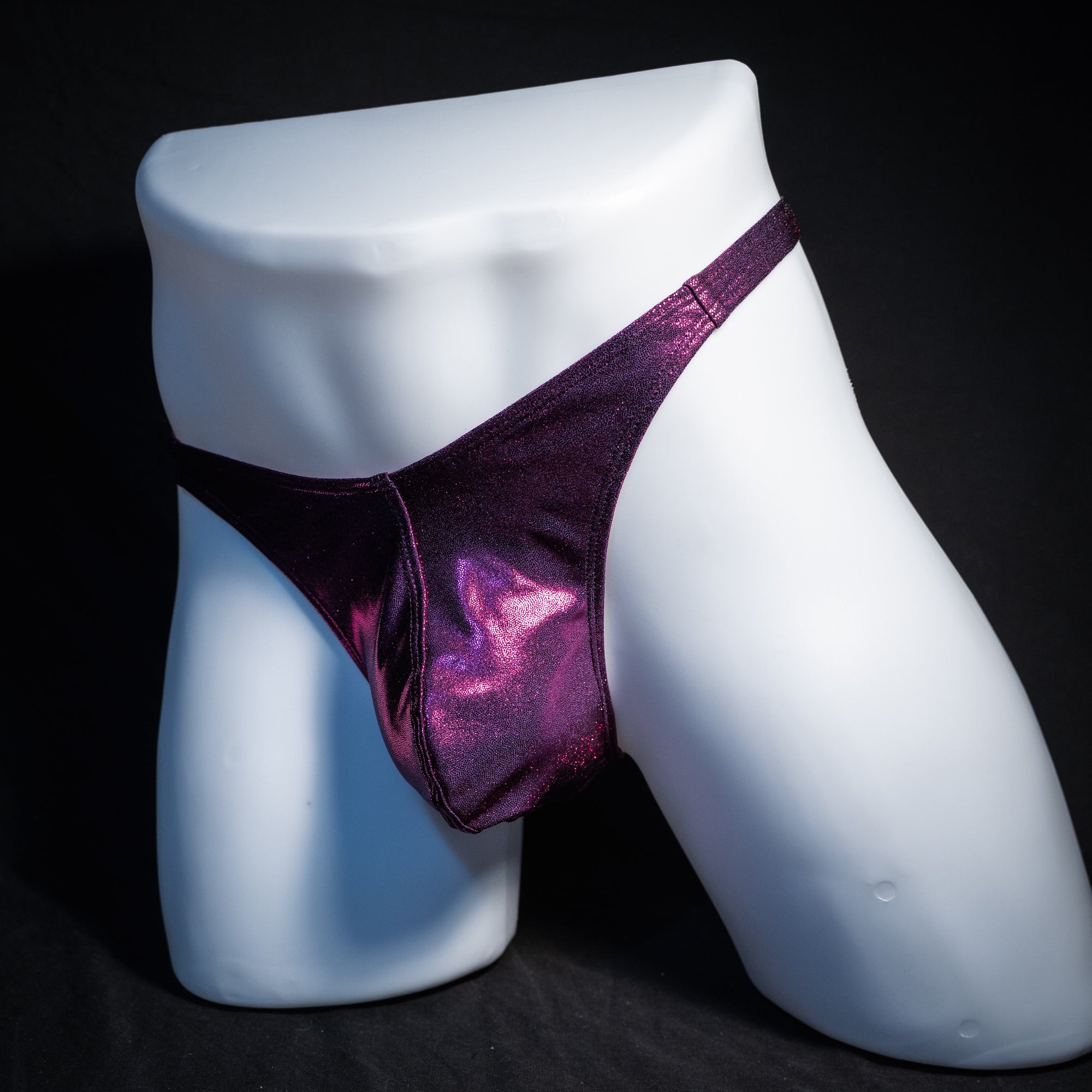 Men's fuchsia metallic thong underwear, classic cut, front view.