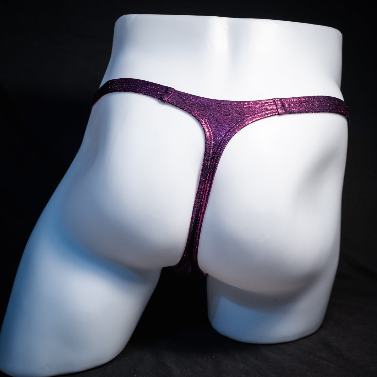 Men's fuchsia metallic thong underwear, classic cut, rear view.