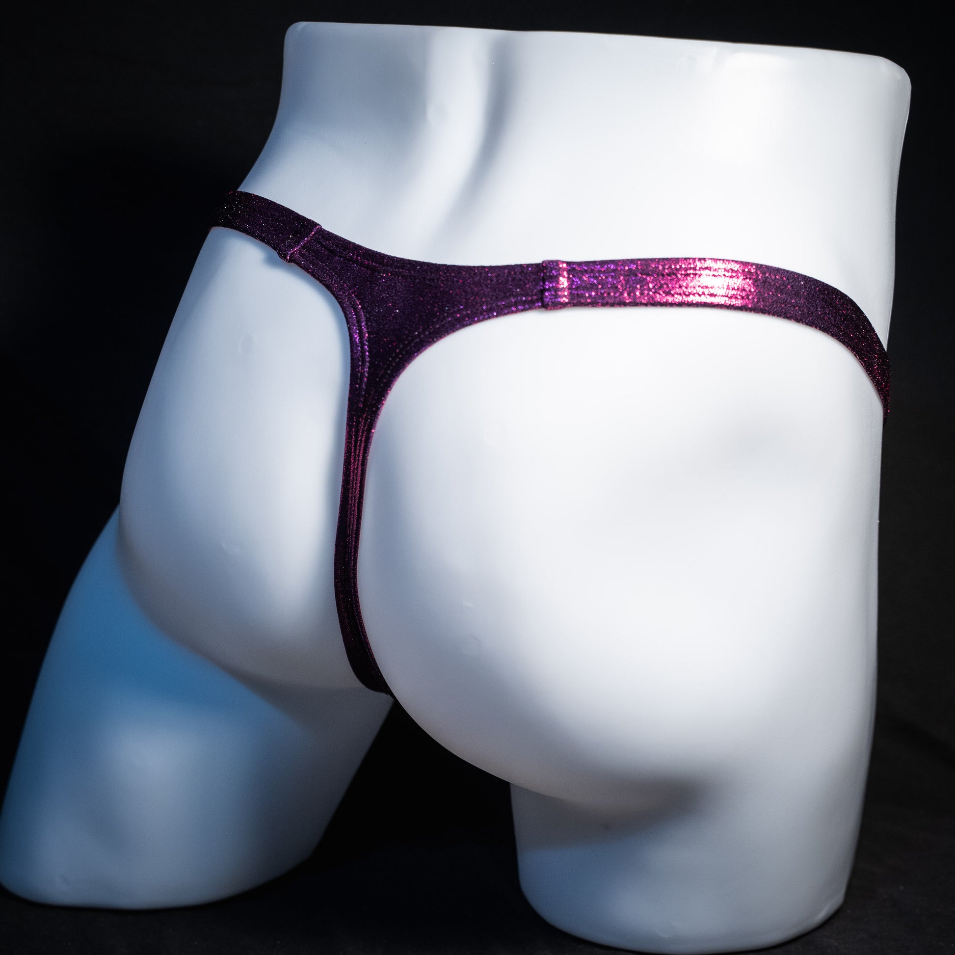 Men's fuchsia metallic thong underwear, classic cut, rear view.