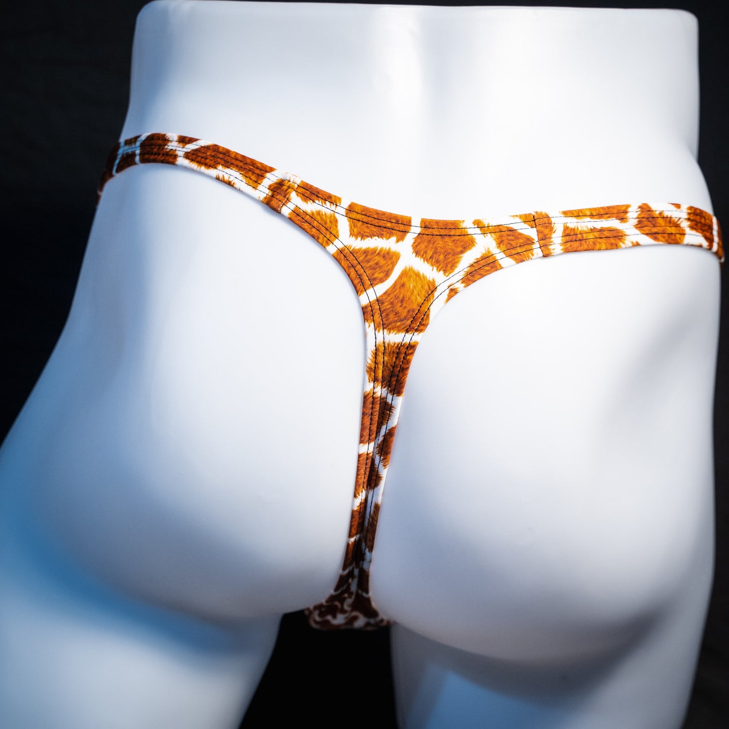 Men's giraffe print thong underwear, classic cut, rear view.
