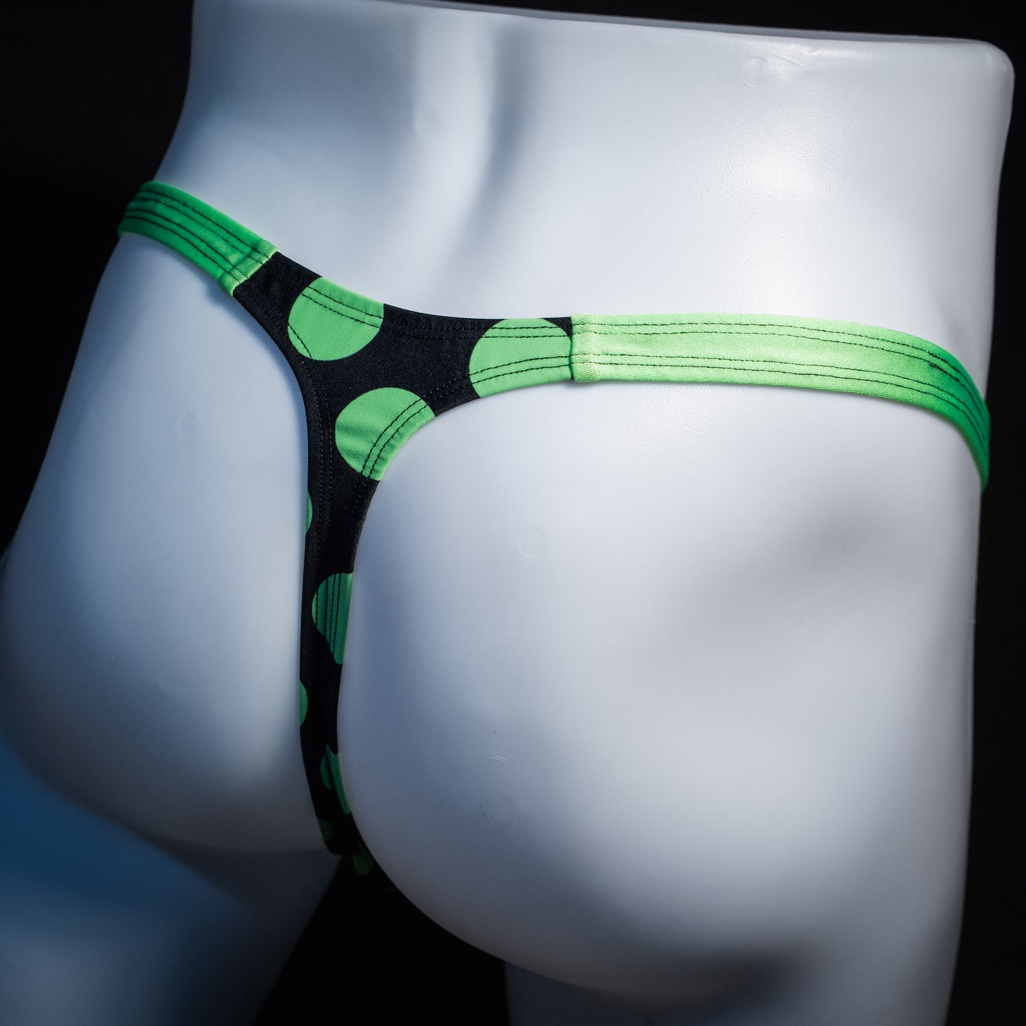 Men's green and black polka dot thong underwear, classic cut, rear view.