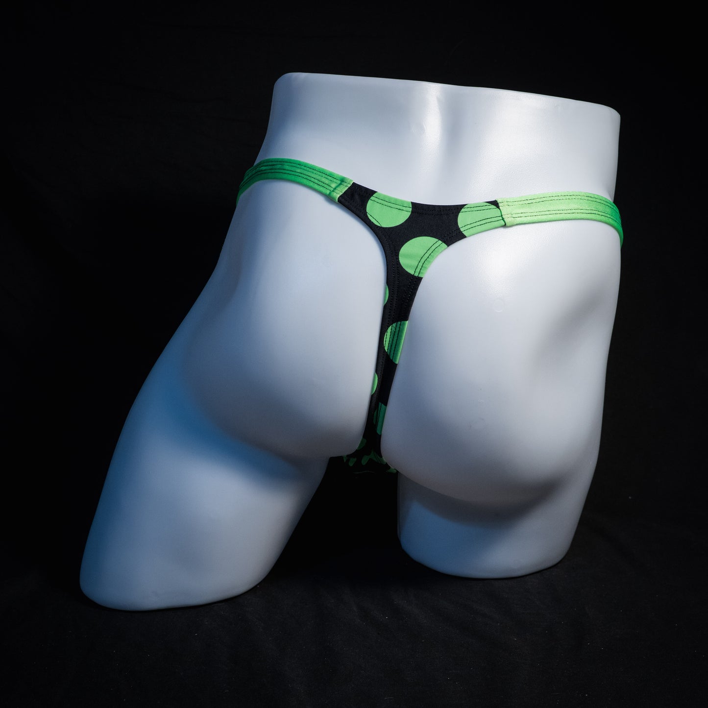 Men's green and black polka dot thong underwear, classic cut, rear view.