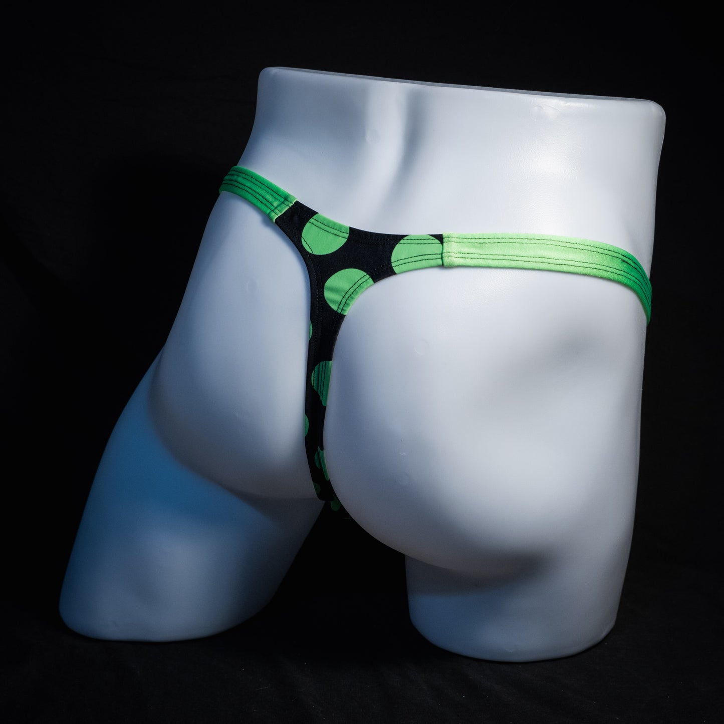 Men's green and black polka dot thong underwear, classic cut, rear view.