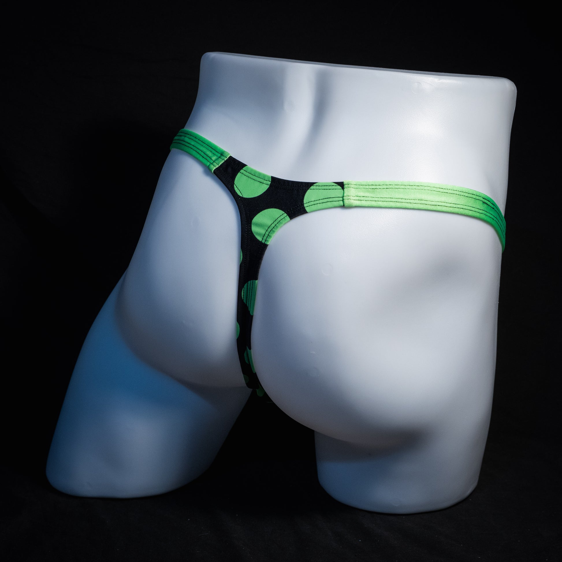 Men's green and black polka dot thong underwear, classic cut, rear view.