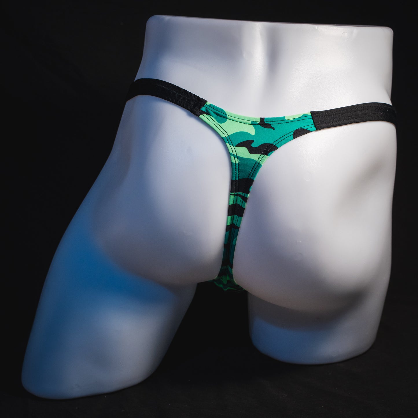 Men's green camo with black straps thong underwear, classic cut, full rear view.