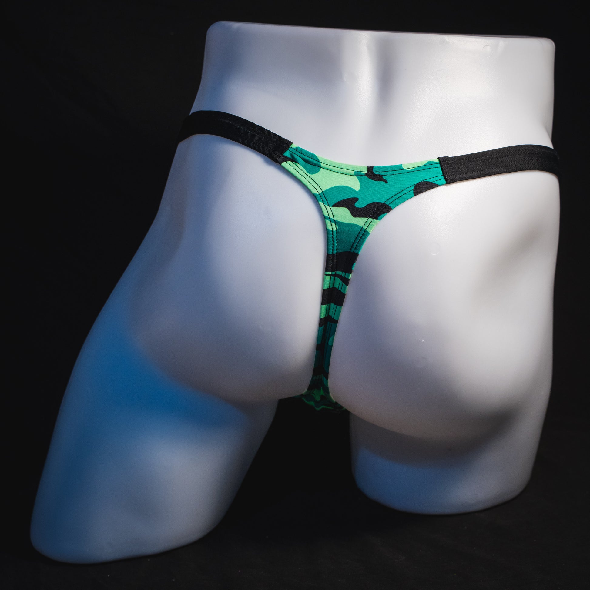 Men's green camo with black straps thong underwear, classic cut, full rear view.