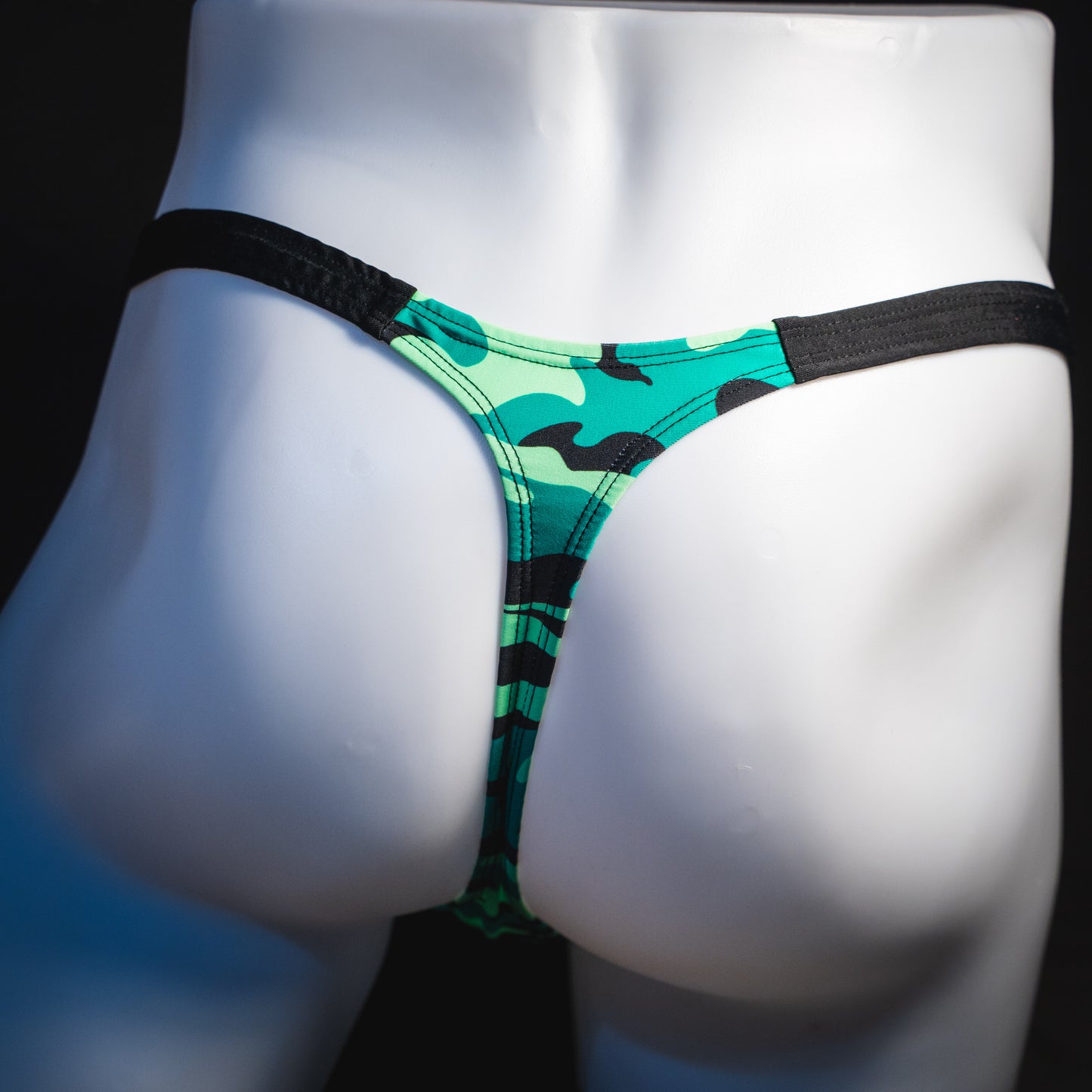 Men's green camo with black straps thong underwear, classic cut, rear view.
