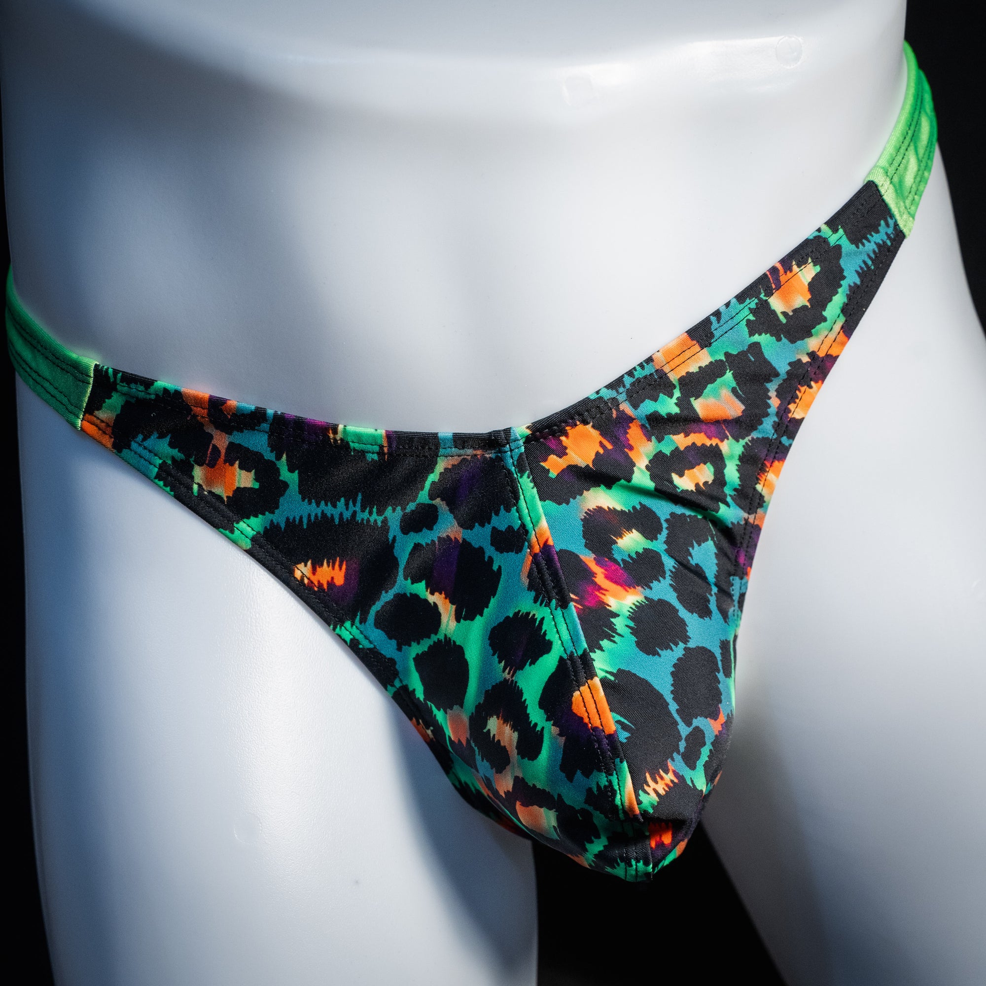 Men's green cheetah thong underwear, classic cut, front view.
