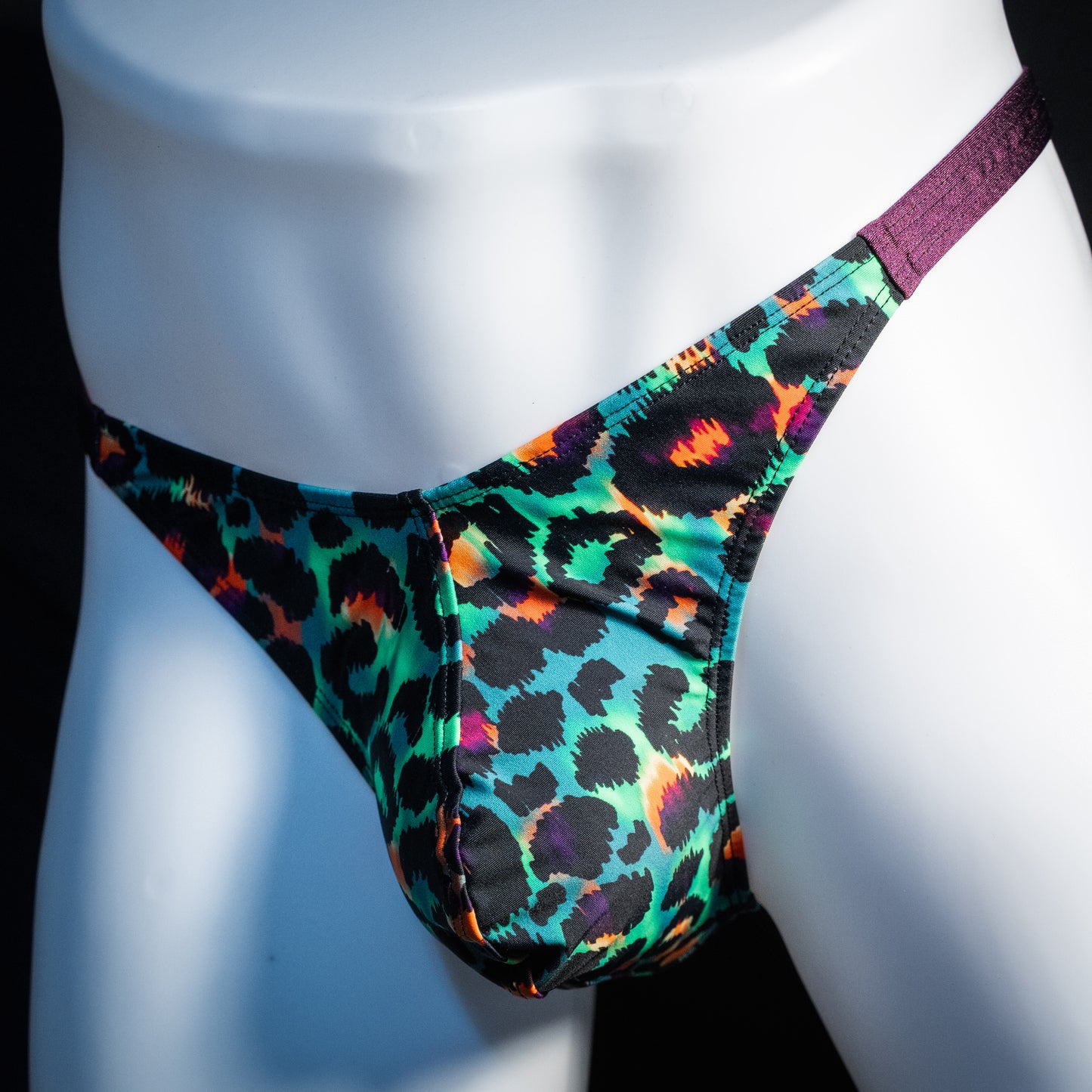 Men's green cheetah thong underwear, classic cut, front view.